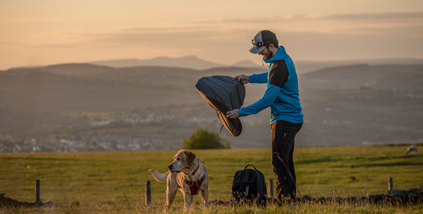 Man and his dog snowboarding.