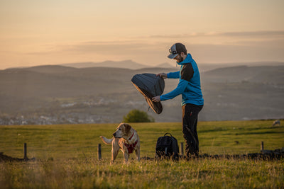 Man and his dog snowboarding.