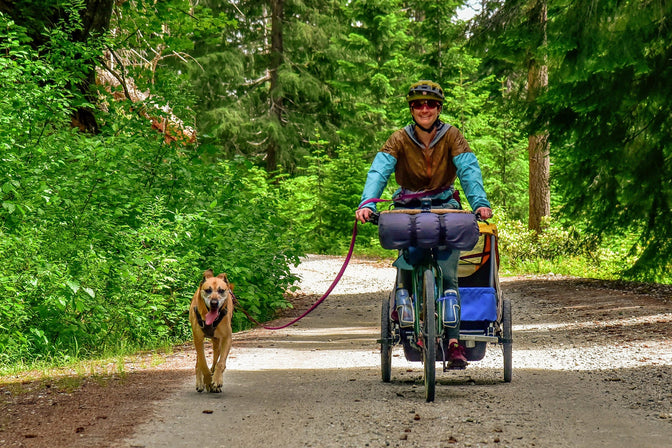 Laura bikepacks with her dog.